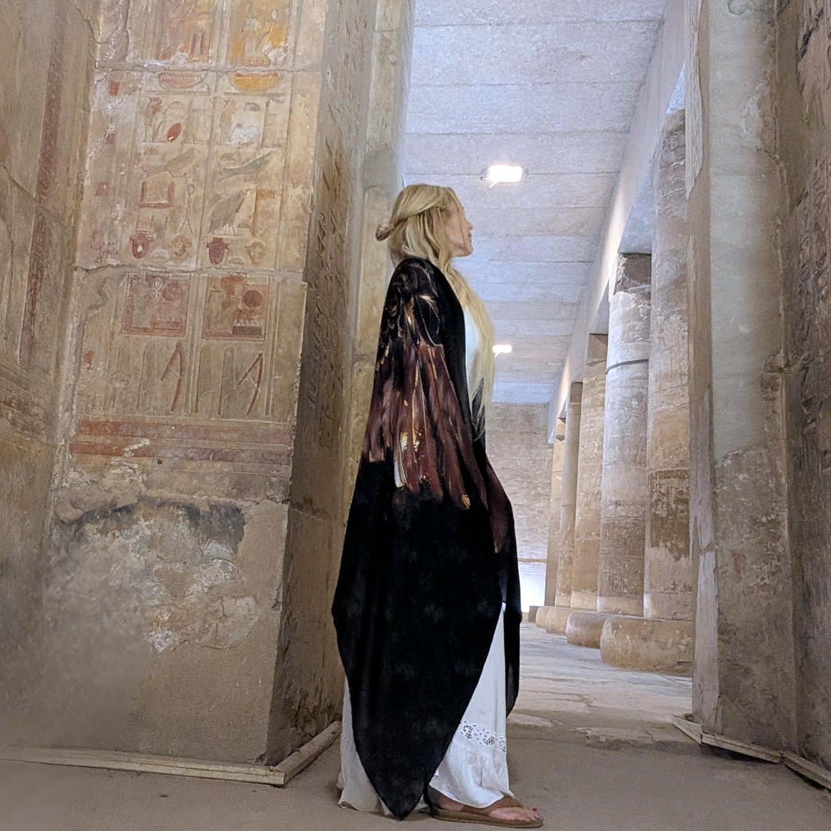 Strength Shawl brown and gold angel wing healing shawl draped over the shoulders in an Egyptian temple