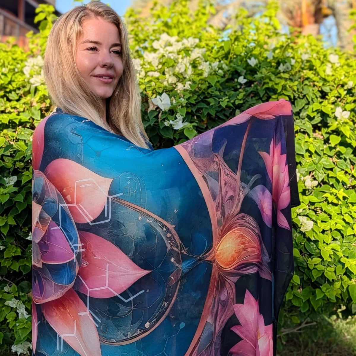 Woman holding the Calm Shawl open to show the blue and pink lotus mandala artwork - spiritual healing shawl