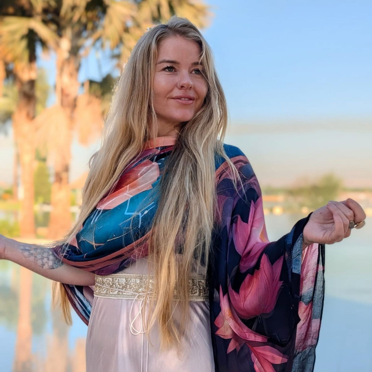 Calm Shawl styled as a boho festival wrap, pink lotus mandala design on soft vegan silk