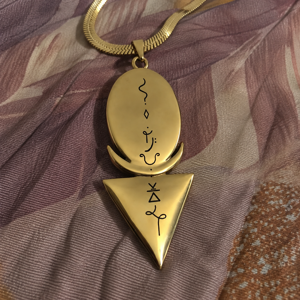 Back of the priestess necklace pendant showing engraved sacred symbols - gold spiritual jewellery