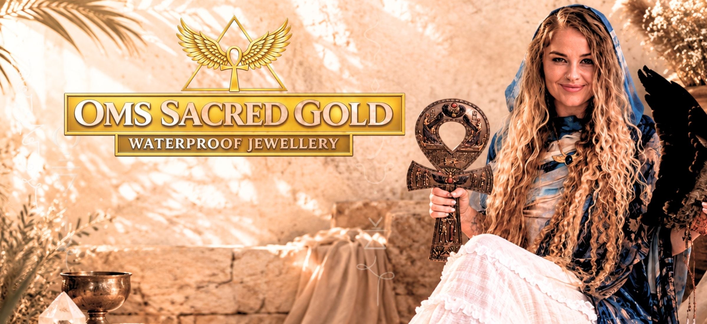 OMS Sacred Gold waterproof jewellery banner featuring woman in blue ceremonial shawl with ancient Egyptian inspired styling and sacred gold jewellery