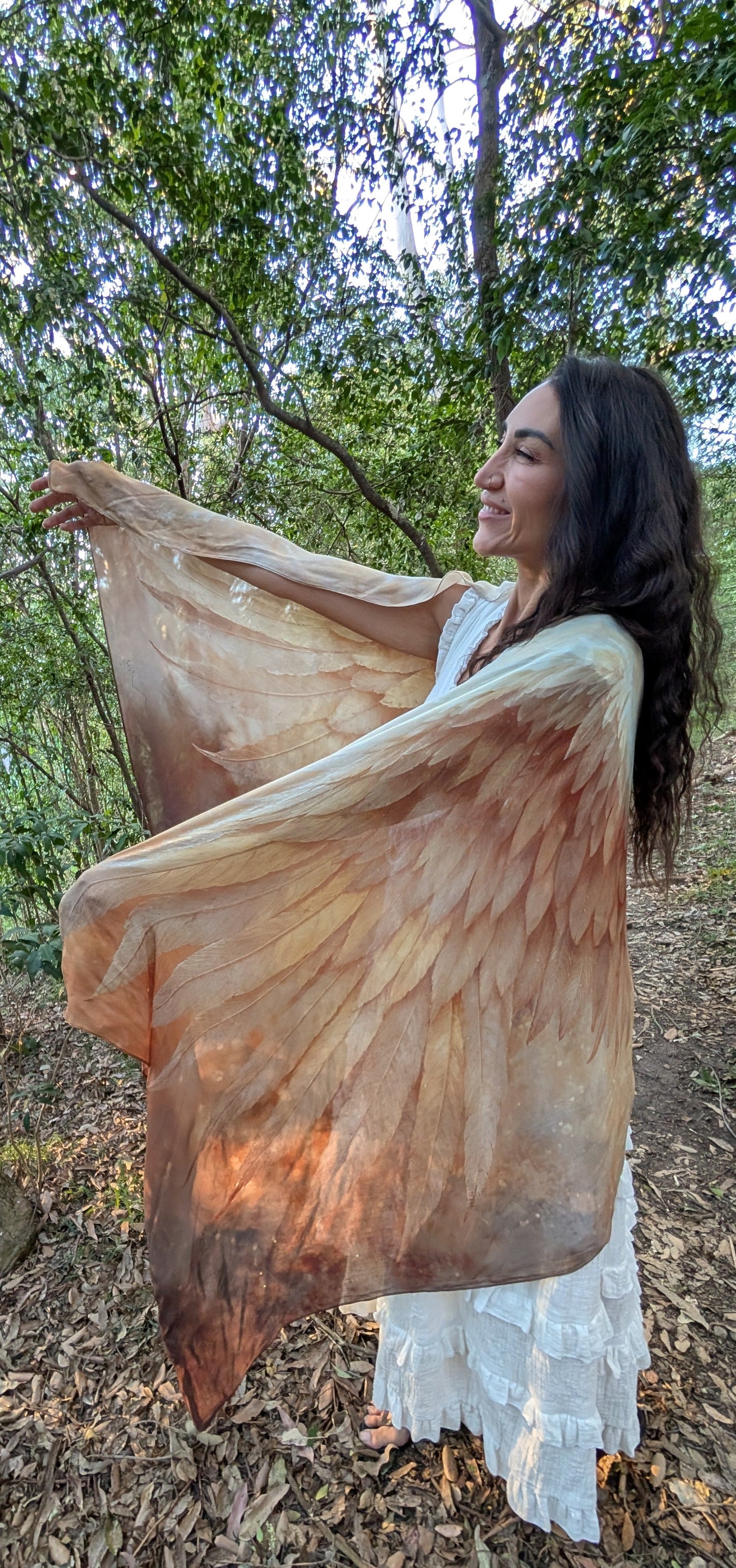 Woman wearing the Abundance Shawl, a boho kimono-style wrap with golden angel wings, styled as everyday bohemian clothing