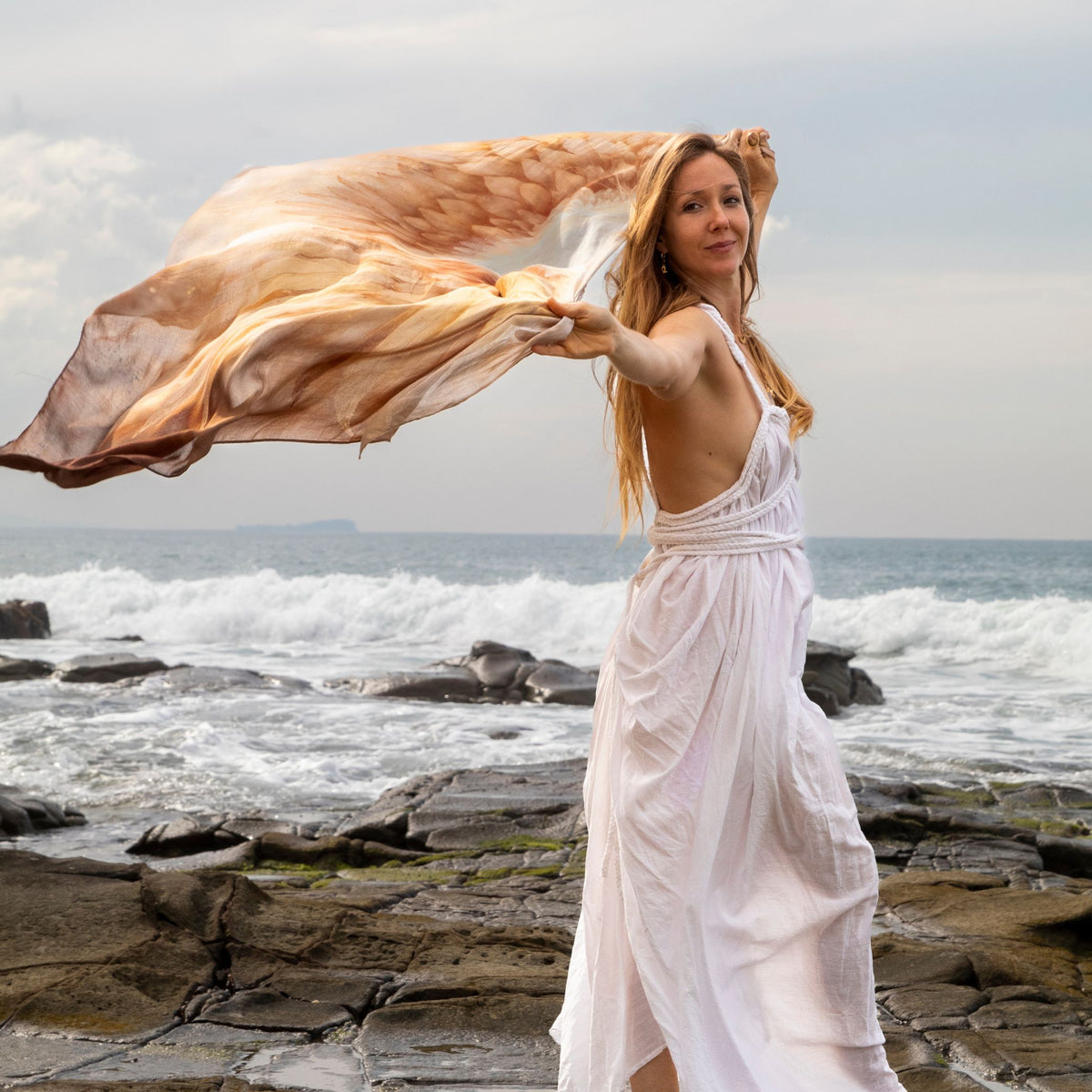 Abundance Shawl flowing in the sea breeze at the beach, golden angel wings vegan silk ceremonial wrap
