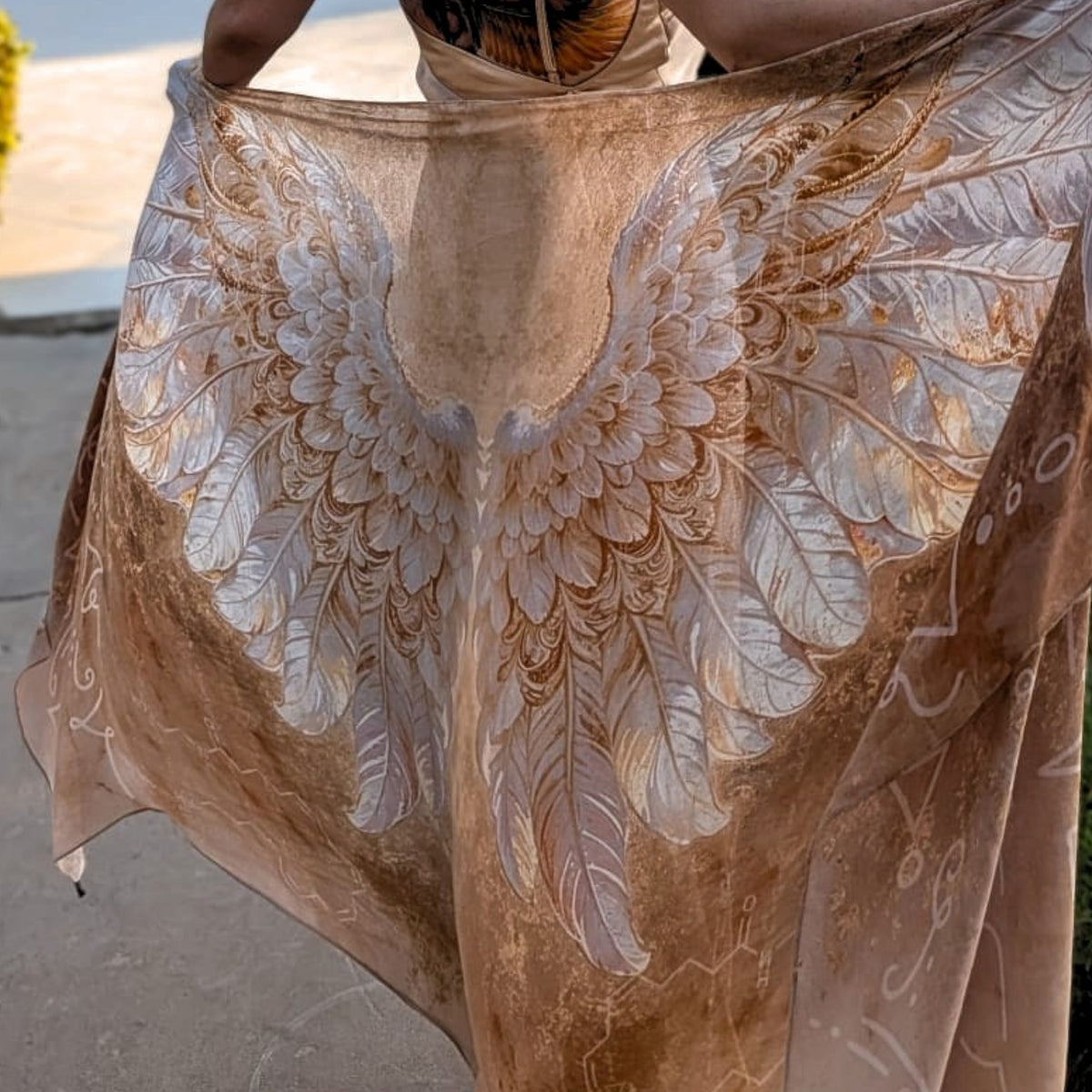Safety Shawl gold and white angel wings vegan silk healing shawl held open, close-up of the feather print