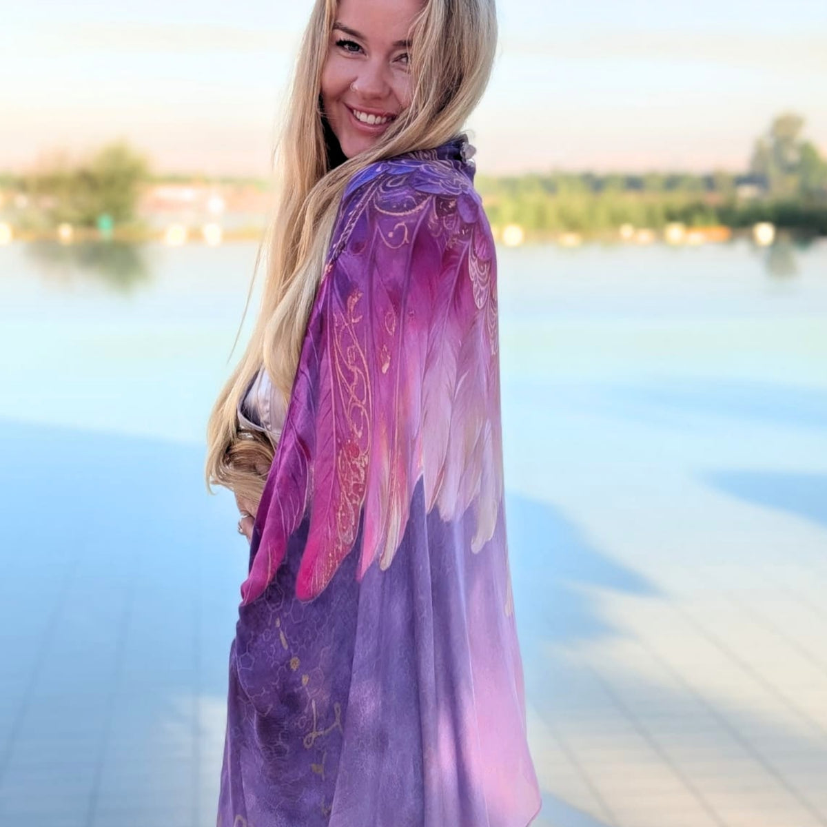 Happiness Shawl purple and pink angel wings draped over the shoulders by the river