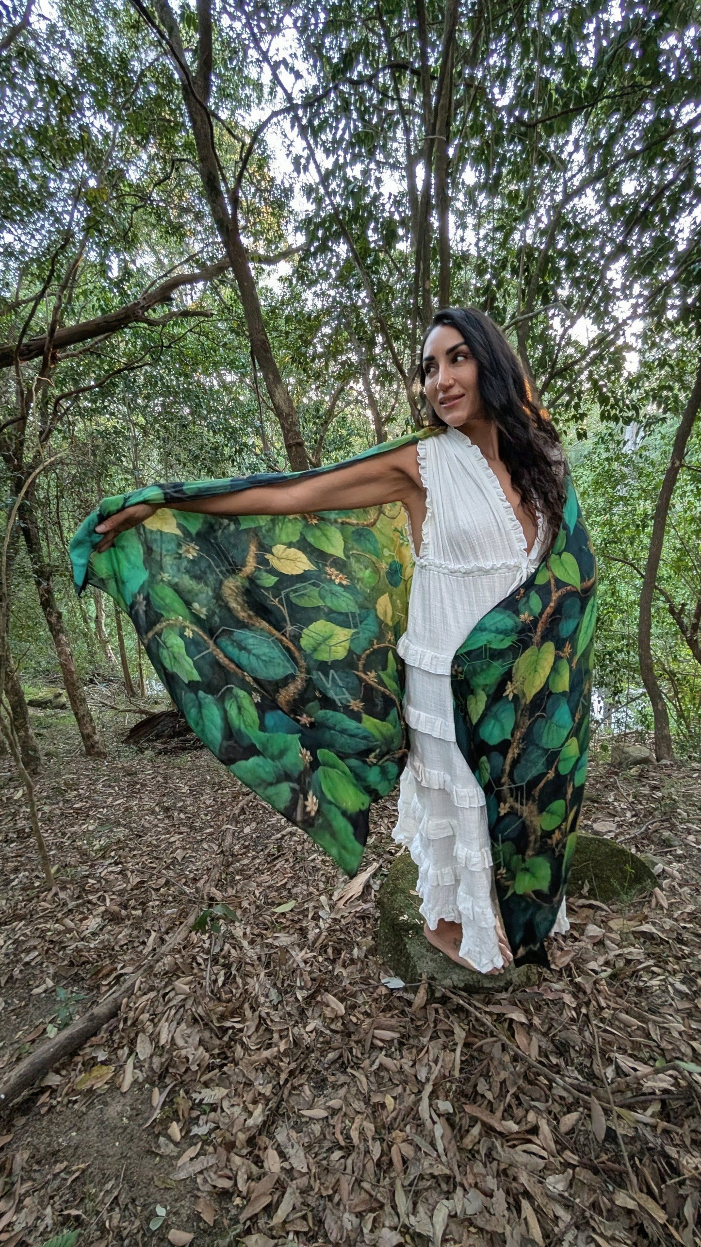 Woman wearing the Grounded Presence Shawl as bohemian festival wear, Ayahuasca leaf print scarf