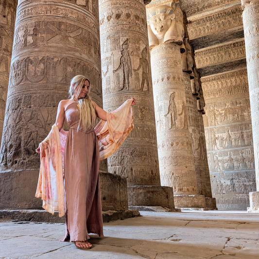 Woman in an ancient Egyptian temple wearing the Powerful Expression lioness shawl as a flowing wrap